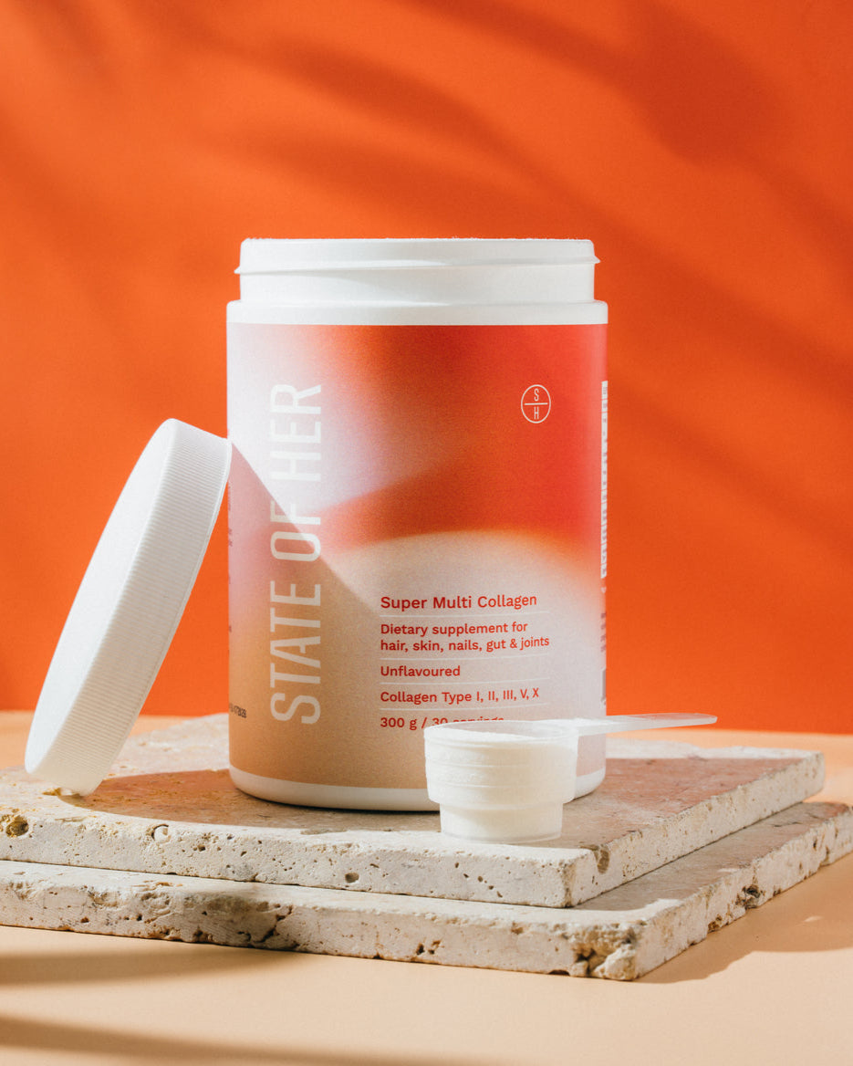 Supplement container labeled 'State of Well' on a wooden surface with an orange background